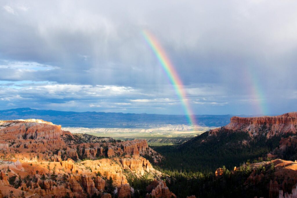 rainbow reflects near mountains