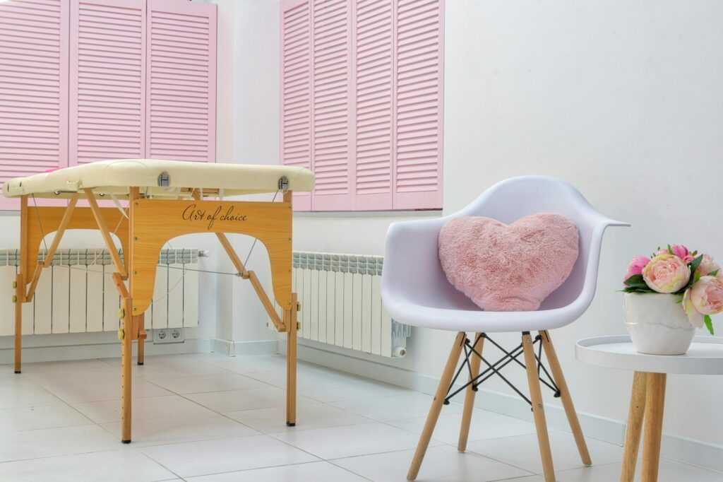 massage salon interior with furniture and blooming peonies in pot