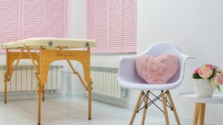 massage salon interior with furniture and blooming peonies in pot