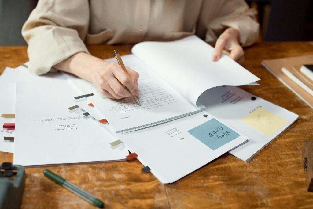 person writing on white paper